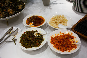 Traditional chinese food gourmet meal or local cuisine cultural tribe bean vegetable in chili paste with variety seasoning side dish serve customer people taste eat drink at Zhangjiajie in Hunan China