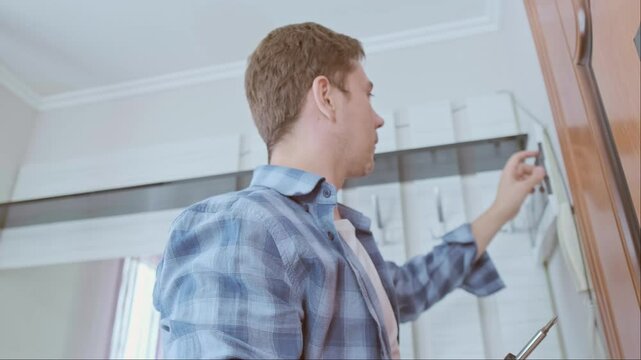 An electrician installs and inspects circuit breakers, ensuring a stable and safe electrical system in the house.