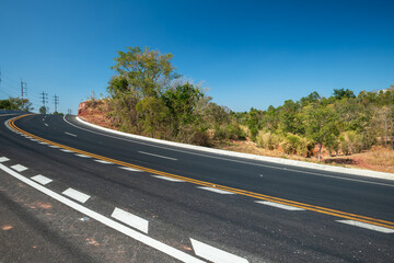 Side view of asphalt road over the hills with blue sky and beautiful mountains, Road background.