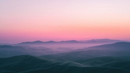 Fototapeta premium Serene Landscape with Soft Colors at Dawn Over Rolling Hills and Gentle Mountain Silhouettes