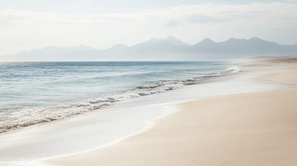 Fototapeta premium Serene Beach Scene with Gentle Waves and Distant Mountains Under Soft Morning Light