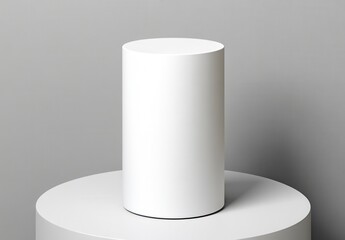 White cylindrical object on a white circular platform against a gray background. Minimalist product display.