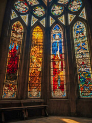 Obraz premium Cross and stained glass windows illuminated by sunshine.