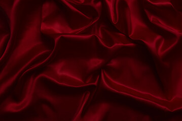 The top view of the red satin surface looks luxurious and beautiful. with sparkling waves Abstract background design copy space Card or banner (blurred or blurry)