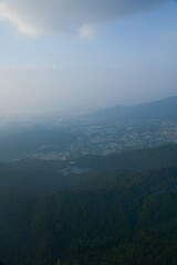 Looking from the airplane window with Hong Kong cityscape. The view of Hong Kong city, Hong Kong landscape from the above. Landscape, travel concept and nature scene. 