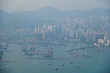 Looking from the airplane window with Hong Kong cityscape. The view of Hong Kong city, Hong Kong landscape from the above. Landscape, travel concept and nature scene. 