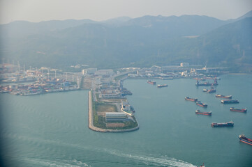 Looking from the airplane window with Hong Kong cityscape. The view of Hong Kong city, Hong Kong landscape from the above. Landscape, travel concept and nature scene. 