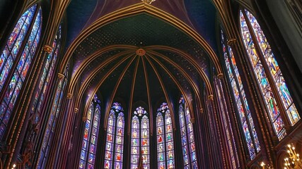 Stunning stained glass artistry adorns a historic cathedral ceiling during midday