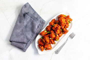 Gobi Manchurian is a crispy, spicy Indo-Chinese dish made with battered, fried cauliflower tossed...