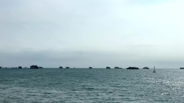 Ferry Ships Queuing to Docking in the Selat Sunda with a Scenic Ocean View and Cloudy Sky