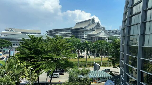 Jakarta March 8 2025: Modern Tzu Chi Center Building in PIK Surrounded by Lush Greenery and Clear Blue Sky