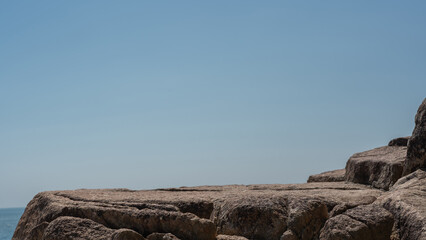 Rock, Stone stage in nature with sea sand beach seashore landscape and blue sky nature backgrounds...