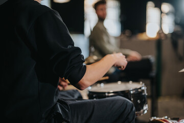 Musicians rehearsing during a band practice session in a creative setting