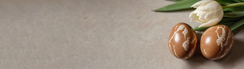 Composition of Easter eggs and white tulips on a marble background