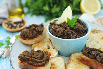 A bowl with tapenade - traditional olive dip in Mediterranean region