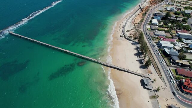 Aerial view of Port Noarlunga Beach and jetty with beautiful blue ocean and sandy shore, Adelaide, South Australia, Australia.