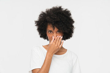 Beautiful young afro-american woman girl in casual clothes and long black hair smelling stinky,...