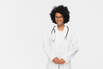 Portrait of positive female African American doctor or nurse posing with crossed arms and smiling...