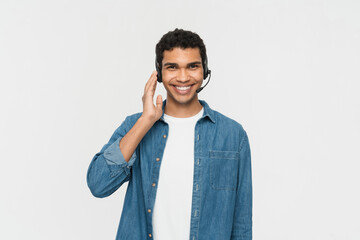 Smiling african american man wearing wireless headset talking to microphone looking at camera isolated on white background with copy space, black call center operator, customer service agent portrait