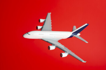 Plane model in air on red background, closeup