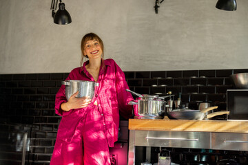 A woman in a relaxed home setting stirs ingredients in a mixing bowl, enjoying a slow morning in...