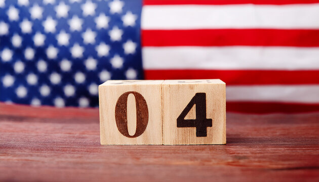 Wooden cube with number 4 on table in front of blurred American flag. The USA. - Powered by Adobe