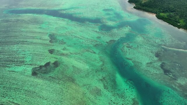 Aerial view of beautiful turquoise reef and calm waves in the ocean, Namaqumaqua, Central, Fiji.