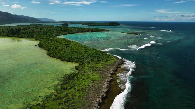 Aerial view of tropical reef and serene coastline with lush greenery, Goro, South Province, New Caledonia.