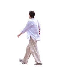 Fototapeta premium Une jeune femme vue de profil qui marche au printemps, vêtue d’une chemise blanche et d’un pantalon beige