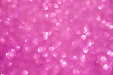 A soft pink bokeh-style background with unfocused light creates an elegant space for text or design elements.