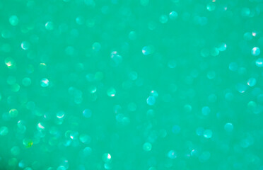 A turquoise bokeh-style background with defocused light creates an elegant space for text or design elements.