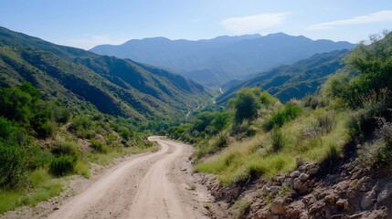 Beautiful winding dirt road through lush green hills and mountains on a sunny day : Generative AI