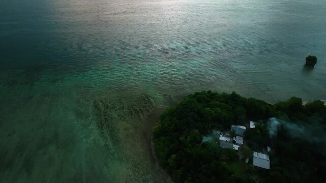 Aerial view of moody tropical island with serene reef and lush greenery, Port Vila, Shefa, Vanuatu.