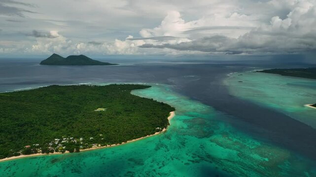 Aerial view of beautiful tropical beach with serene shoreline, azure waves, and lush palms, Port Vila, Shefa, Vanuatu.