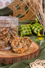 Celebration cookies, Florentine cookies in a glass jar and wooden board . Gluten free biscuits made from mixed nuts and dried fruits as a healthy choice. 