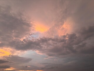 Beautiful sky with natural gradations. Thick clouds in the dusk sky on a winter night. Image of a cloudy sky in the afternoon. View of the night sky with golden light from the evening sun	
