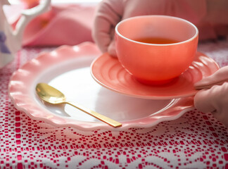 A pink antique tea cup, at a tea party 