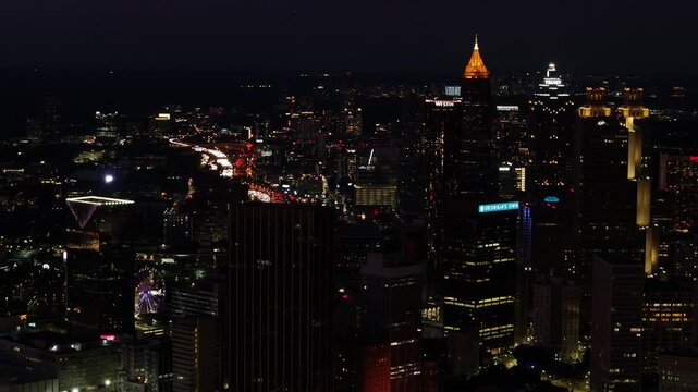Atlanta, United States - 01 February 2025: Aerial view of vibrant downtown skyline illuminated at night with bustling city lights, Atlanta, Georgia, United States.