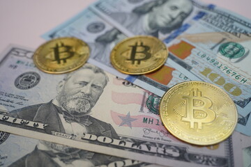 Dollar bills on the table and coins with the bitcoin symbol. Mining.