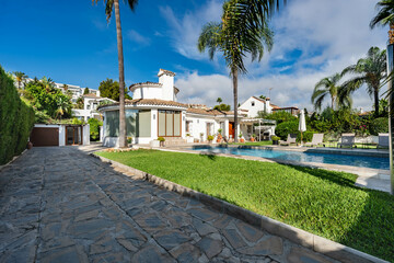 an image from a mediterranean luxury villa overlooking the private swimming pool and garden with palm trees 