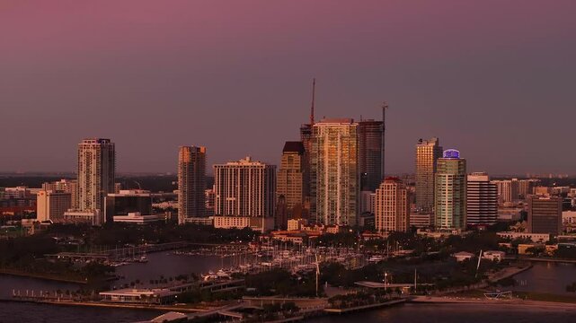 Aerial view of downtown skyline at sunrise with St. Pete Pier and marina, St. Petersburg, Florida, United States.