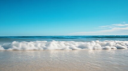 Fototapeta premium Serene ocean view with gentle waves lapping on the sandy shore under a clear blue sky : Generative AI