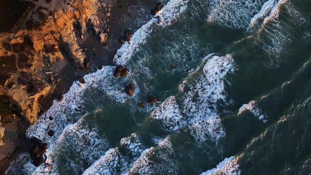 Aerial view of Point Reyes with crashing waves and rugged cliffs, Dillon Beach, California, United States.