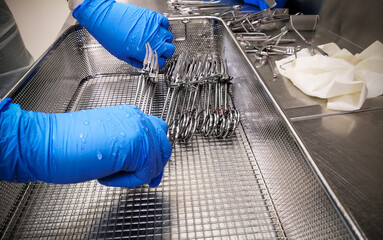 Nurse Cleaning and Arranging Medical Surgical Instrument for Washing and Reprocessing
