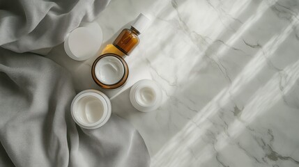 Skincare products on marble, sunlight, fabric background, beauty blog