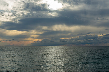 Obraz premium Beautiful sunset. Warm summer evening on the Black Sea coast. The sea is calm, the sea is smooth and calm.