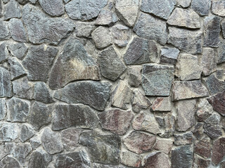 Panoramic background of old stone wall texture.  Wall made of large stone in brown tones. Background for home or office design