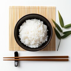 Steaming Rice Delight: A close-up, top-down perspective showcases a bowl of perfectly cooked, fluffy rice presented alongside chopsticks on a bamboo mat.