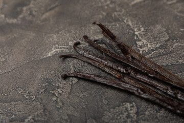 Vanilla pods on a textured background. Vanilla flowers and seeds. vanilla stick bean. Aromatic...