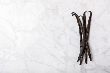 Vanilla pods on a textured background. Vanilla flowers and seeds. vanilla stick bean. Aromatic...